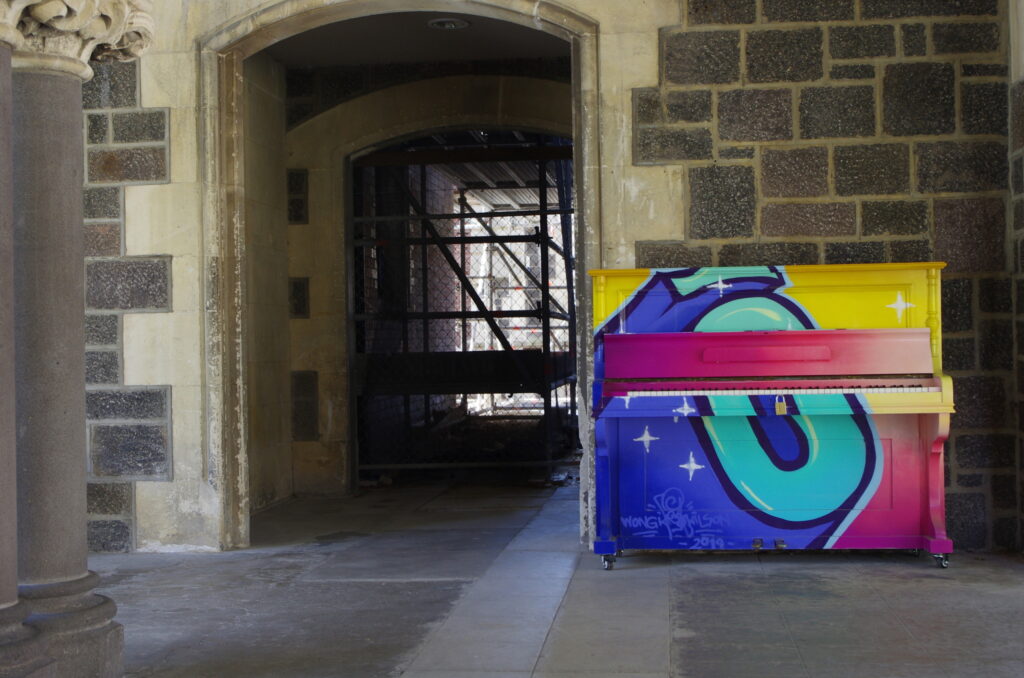 Colourful public piano in gothic building